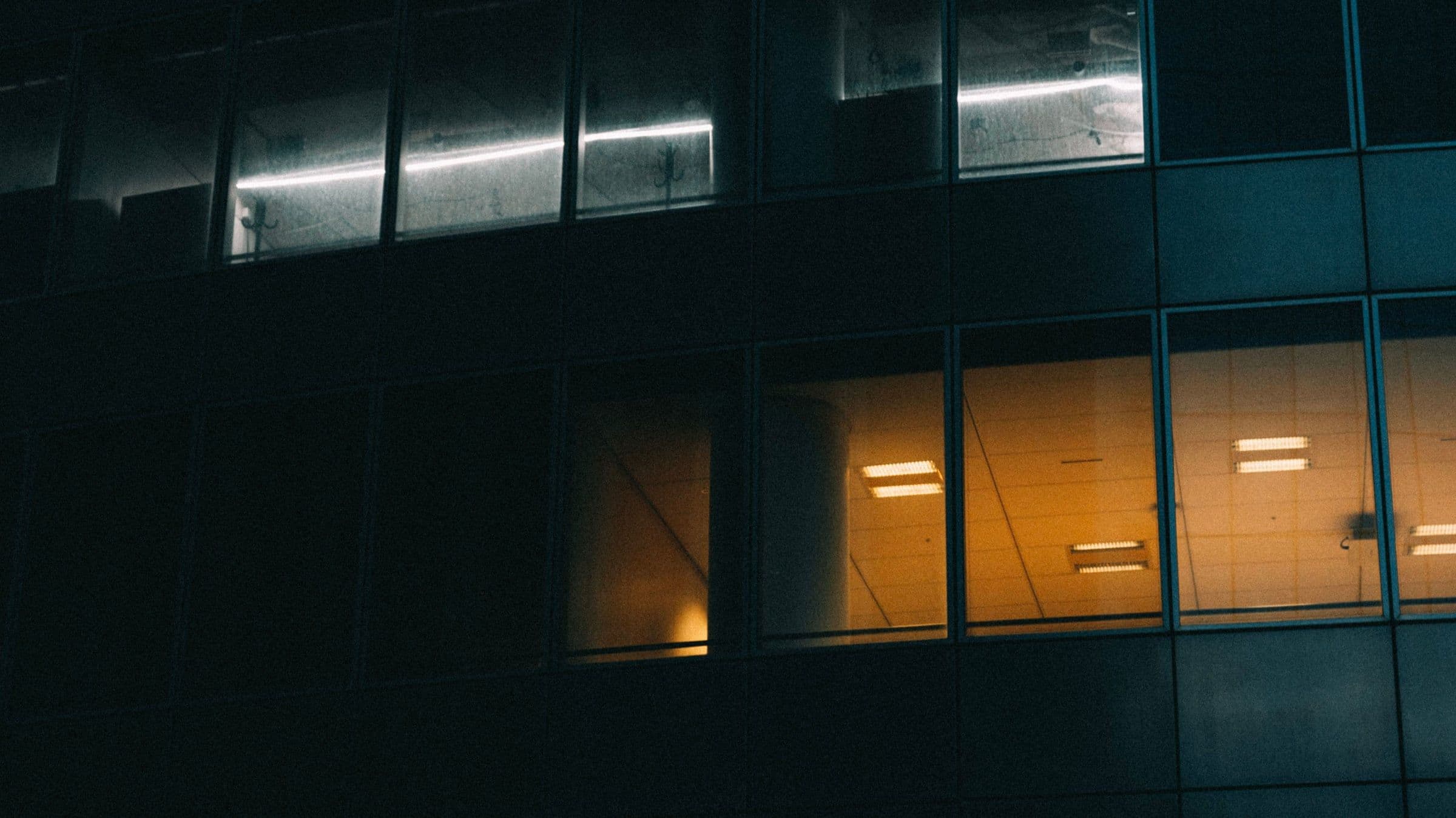 An office tower lit from within after hours